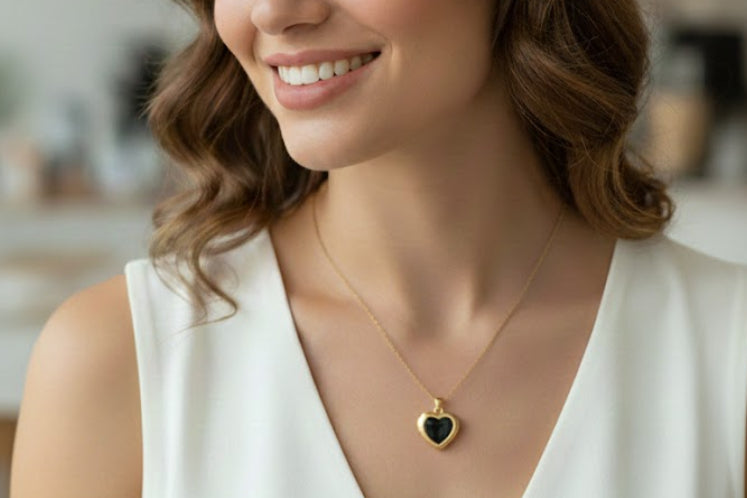 Woman wearing a necklace with a heart pendant in a blurred indoor setting